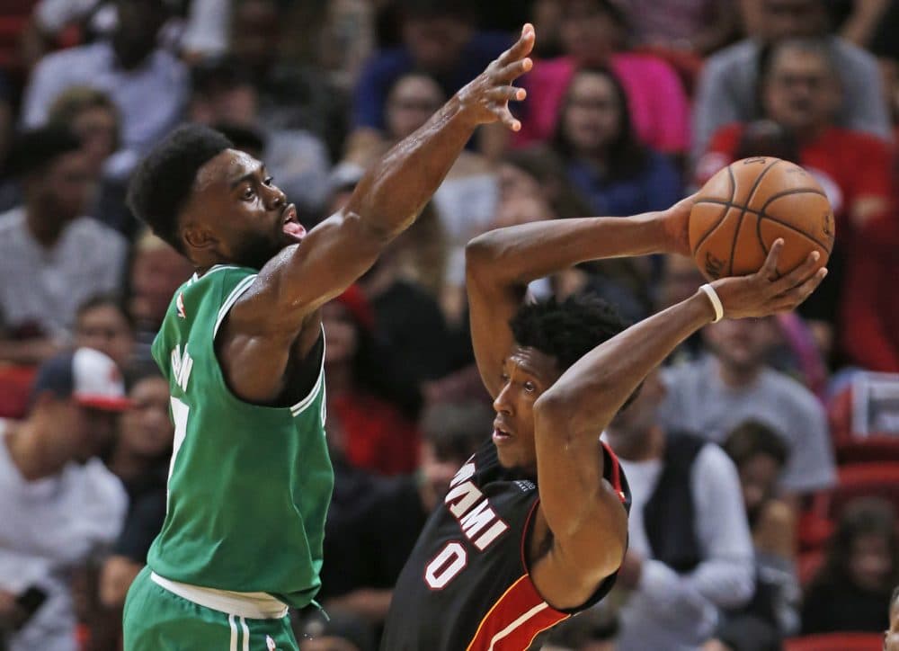 Miami Heat guard Josh Richardson (0) looks for an open teammate past Boston Celtics forward Jaylen Brown (7) during the second half of an NBA basketball game, Saturday, Oct. 28, 2017, in Miami. The Celtics defeated the Heat 96-90. (AP Photo/Wilfredo Lee)