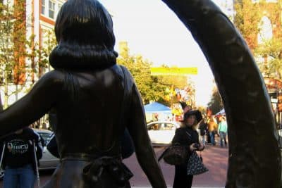 A woman dressed as a witch is framed by a statue in downtown Salem of Samantha Stevens, the witch on the TV show &quot;Bewitched.&quot; 