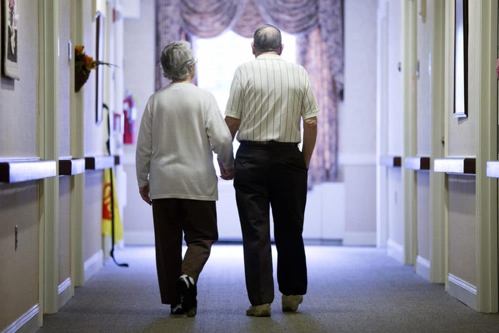 Decima Assise, who has Alzheimer's disease, and Harry Lomping walk the halls, Friday, Nov. 6, 2015, at The Easton Home in Easton, Pa. Nursing homes and assisted living facilities are increasingly using sight, sound and other sensory cues to stimulate memory in people with Alzheimer's disease and other forms of dementia. (AP Photo/Matt Rourke)