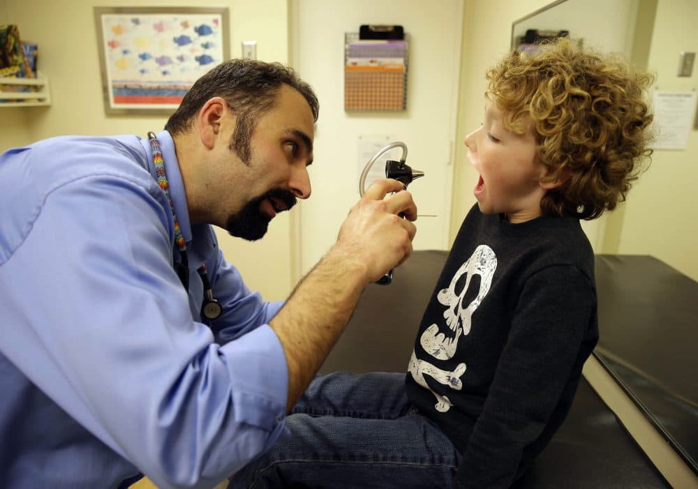 Pediatrician Nelson Branco examines 6-year-old Julien Voy during a medical checkup at the Tamalpais Pediatrics clinic on Feb. 6, 2015, in Greenbrae, Calif. (Eric Risberg/AP)