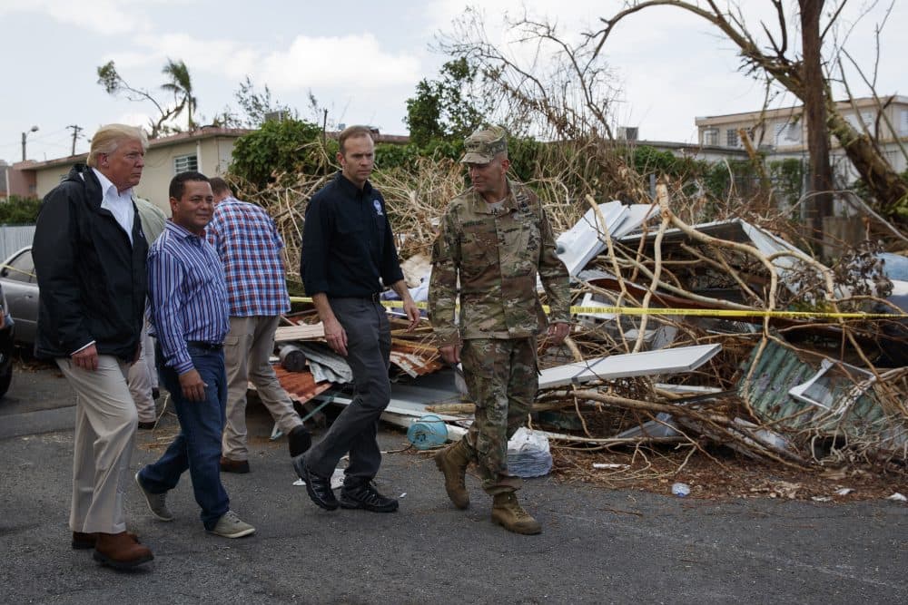 President Donald Trump tours a neighborhood impacted by Hurricane Maria on Tuesday in Guaynabo, Puerto Rico. (Evan Vucci/AP)