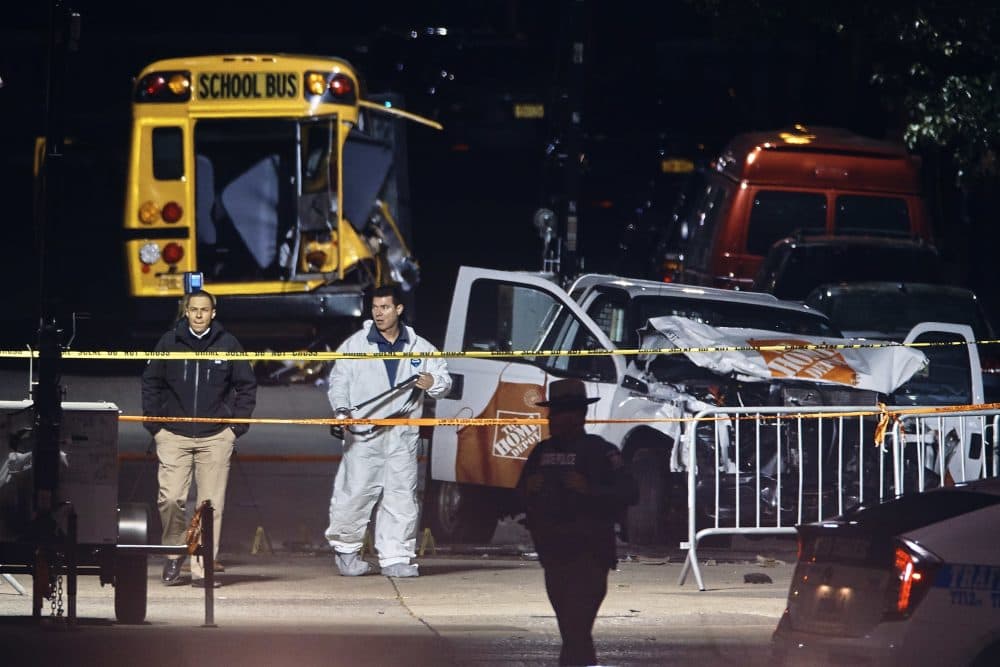 Police work early Wednesday near a damaged Home Depot truck after a motorist drove onto a bike path near the World Trade Center memorial, striking and killing several people in New York. (Andres Kudacki/AP)