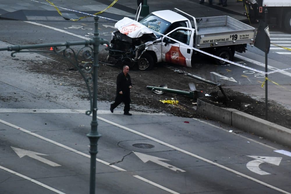 An investigator walks past a crashed pickup truck following an incident in New York on Oct. 31, 2017. A pickup driver killed eight people in New York on Tuesday, mowing down cyclists and pedestrians, before striking a school bus in what officials branded a &quot;cowardly act of terror.&quot; (Don Emmert/AFP/Getty Images)