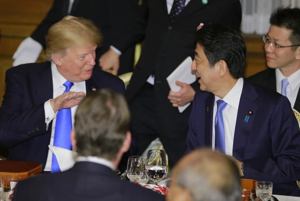 President Trump talks with Japanese Prime Minister Shinzo Abe at the opening of a welcome dinner hosted by Abe at Akasaka Palace in Tokyo on Nov. 6, 2017. (Shizuo Kambayashi/AFP/Getty Images)