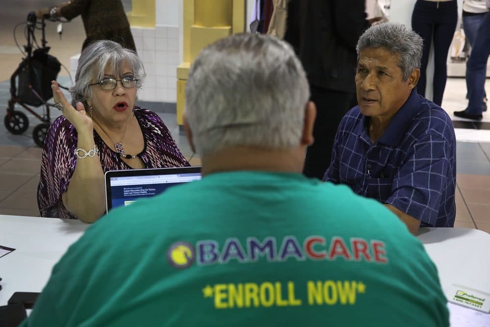 Isabel Diaz Tinoco (left) and Jose Luis Tinoco speak with Otto Hernandez, an insurance agent from Sunshine Life and Health Advisors, as they shop for insurance under the Affordable Care Act at a store setup in the Mall of Americas on Nov. 1, 2017 in Miami, Fla. The open enrollment period to sign up for a health plan under the Affordable Care Act runs until Dec. 15. (Joe Raedle/Getty Images)