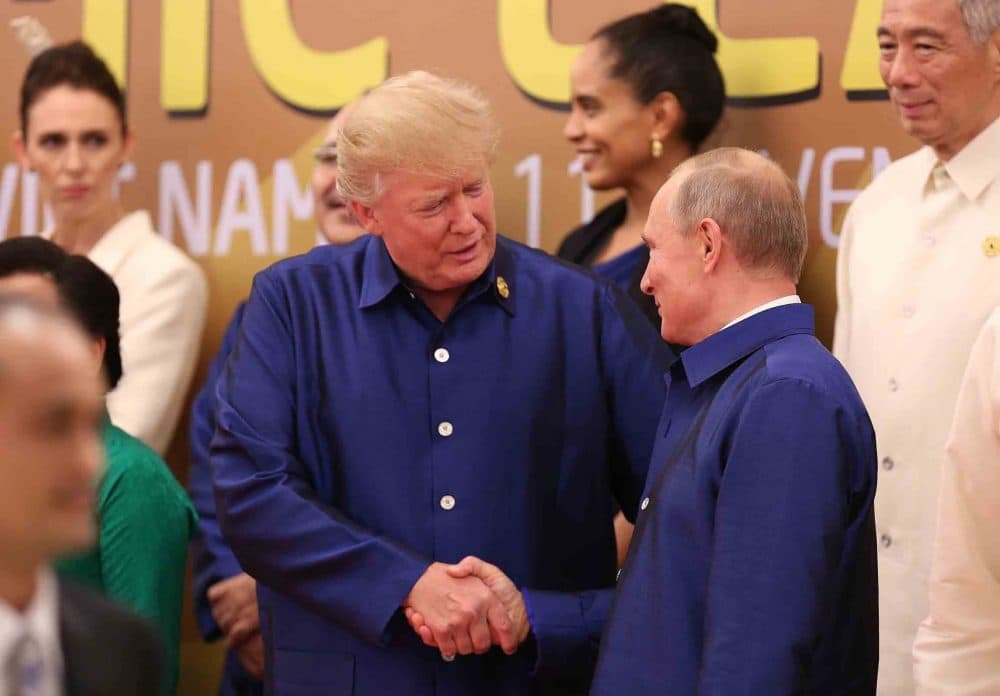 President Trump shakes hands with Russia's President Vladimir Putin as they pose for a group photo ahead of the Asia-Pacific Economic Cooperation (APEC) Summit leaders gala dinner in the central Vietnamese city of Danang on Nov. 10, 2017. (STR/AFP/Getty Images)