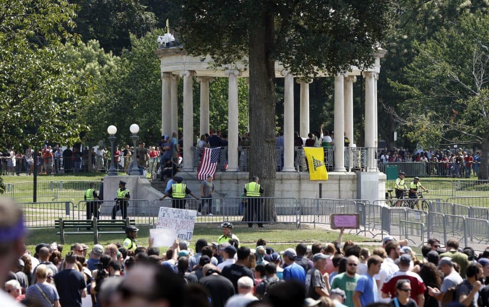 Organizers stand on the bandstand on Boston Common during a self-described &quot;free speech&quot; rally in August. Throngs of counter-protesters stand along barricades separating them from the rally attendees. (Michael Dwyer/AP)