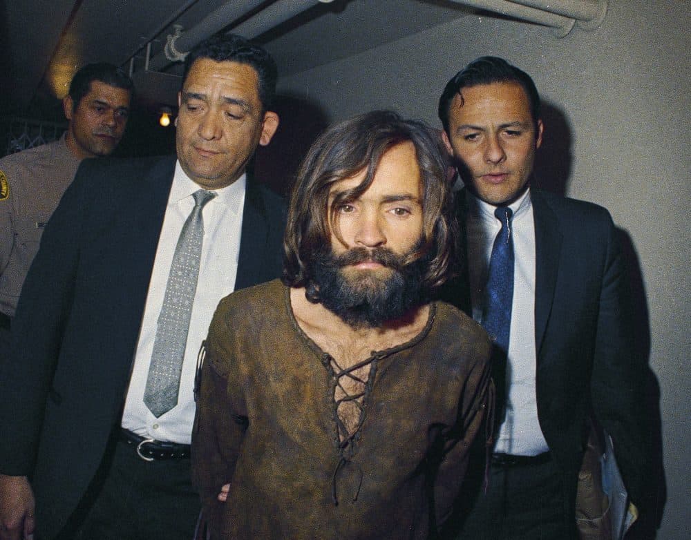 In this 1969 file photo, Charles Manson is escorted to his arraignment on conspiracy-murder charges in connection with the Sharon Tate murder case. Authorities say Manson, cult leader and mastermind behind 1969 deaths of actress Sharon Tate and several others, died on Sunday, Nov. 19, 2017. He was 83. (AP Photo, File)