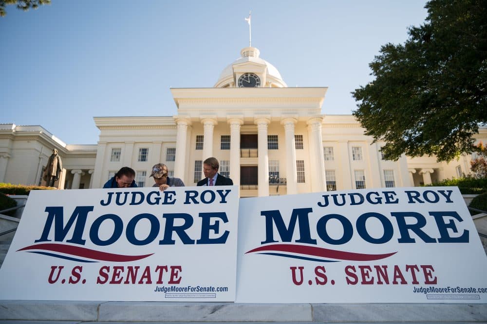 Campaign staff members set up signs before the start of a 'Women For Moore&quot; rally in support of Republican candidate for U.S. Senate Roy Moore, in front of the Alabama State Capitol, Nov. 17, 2017 in Montgomery, Ala. (Drew Angerer/Getty Images)