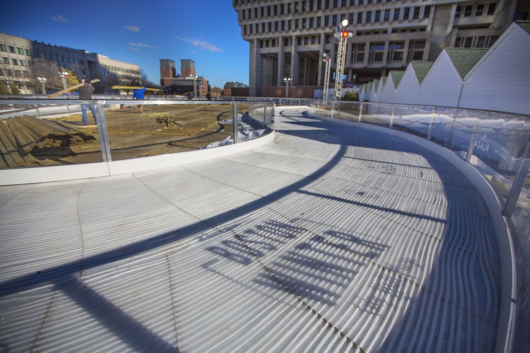 Workers finish putting together the skating rink for &quot;Boston Winter&quot; at City Hall Plaza last year. (Jesse Costa/WBUR)