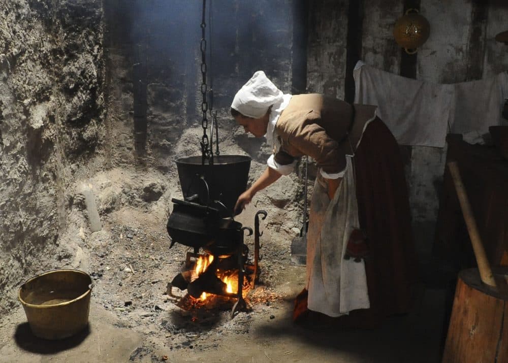 An employee of Plimoth Plantation cooks hasty pudding on Sept. 9, 2008, in Plymouth. (Lisa Poole/AP)