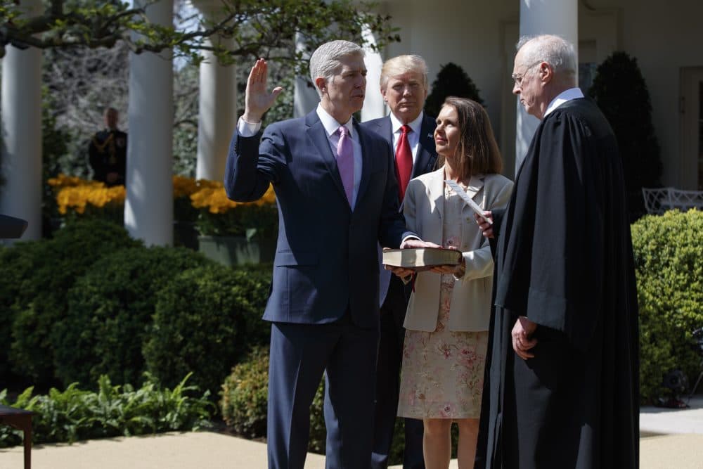 President Donald Trump watches as Supreme Court Justice Anthony Kennedy administers the judicial oath to Justice Neil Gorsuch, accompanied by his wife Marie Louise, during a public swearing-in ceremony in the Rose Garden of the White House in Washington, Monday, April 10, 2017. (Evan Vucci/AP)