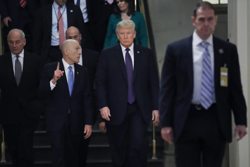President Donald Trump, center, walks next to Paul Irving, left, the House Sergeant at Arms, Thursday, Nov. 16, 2017, on Capitol Hill in Washington. Trump is at the Capitol for a pep rally with House Republicans, shortly before the chamber is expected to approve the tax bill over solid Democratic opposition. At far left is White House Chief of Staff John Kelly. (Jacquelyn Martin/AP)