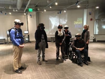 MIT Museum visitors use virtual-reality gear to experience &quot;The Enemy,&quot; Karim Ben Khelifa's exploration of conflict zones and the people who inhabit them. (Courtesy MIT Museum)