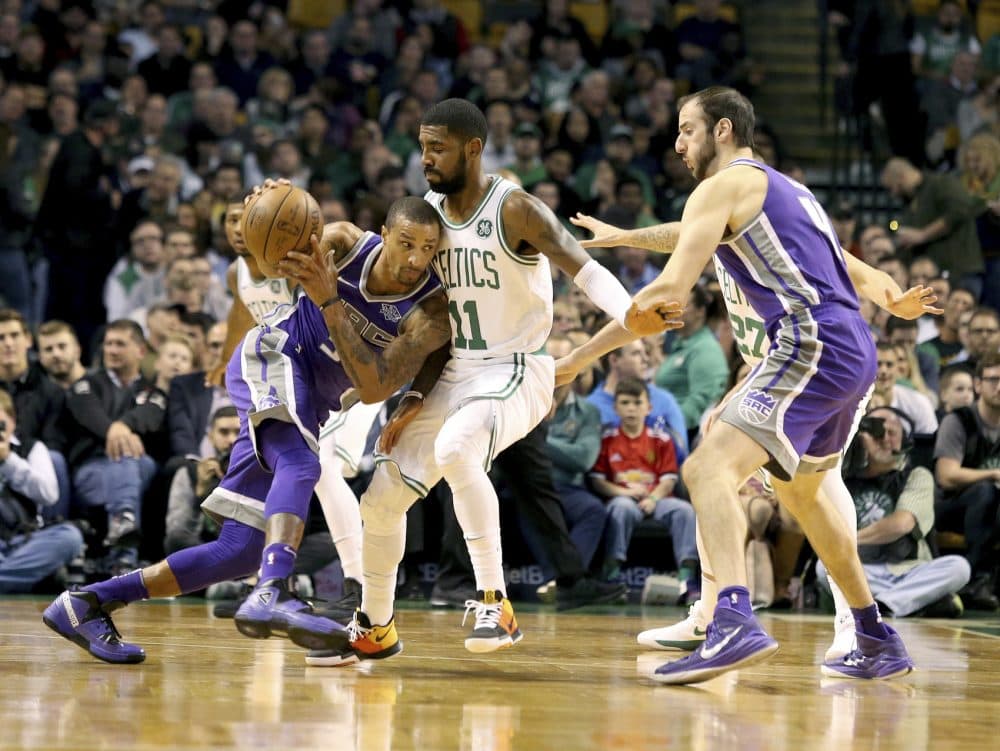 Sacramento Kings' George Hill (3) drives into Boston Celtics' Kyrie Irving (11) during the first half of an NBA basketball game in Boston, Wednesday, Nov. 1, 2017. (AP Photo/Mary Schwalm)