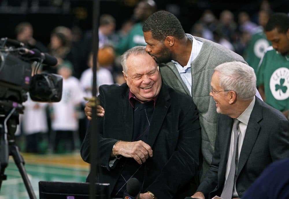 As Celtics braodcaster Tommy Heinsohn (left) and his partner Mike Gorman (right) were sitting courtside doing their pre game piece, former Celtics forward Walter McCarty (center) walked by and planted a kiss on the smiling Heinsohn's forehead. The Boston Celtics hosted the Washington Wizards in a regular season NBA game at the TD Garden in 2012.
(Jim Davis/Globe Staff)