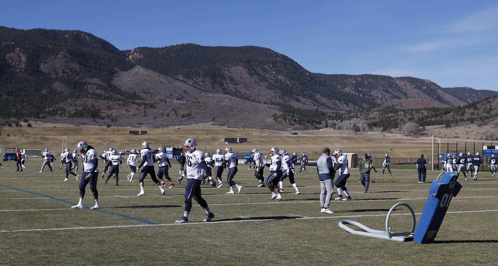 With the surrounding mountains in the background, the New England Patriots take part in drills at NFL football practice, Wednesday, Nov. 15, 2017, on the campus of the Air Force Academy in Air Force Academy, Colo. The Patriots are practicing at Air Force, which is located at an elevation of 7,200 feet, to prepare to face the Oakland Raiders during an NFL football game Sunday in Mexico City, which sits at an elevation of almost 7,400 feet above sea level. (AP Photo/David Zalubowski)