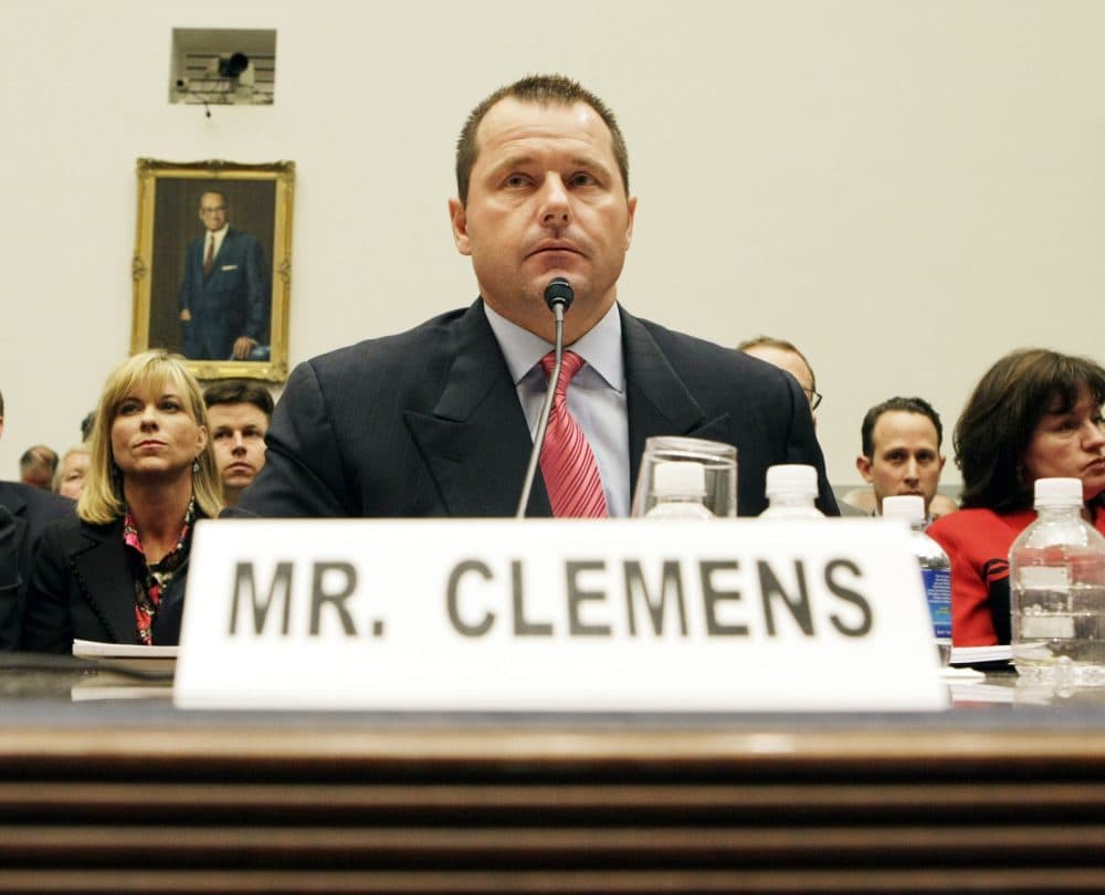 Former New York Yankees baseball pitcher Roger Clemens, center, testifies on Capitol Hill in Washington, Wednesday, Feb. 13, 2008, before the House Oversight, and Government Reform committee hearing on drug use in baseball. At left is his wife Debbie Clemens. (AP Photo/Pablo Martinez Monsivais)