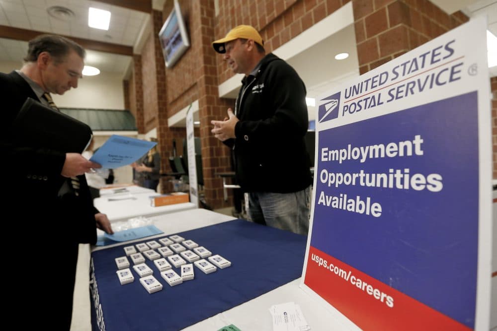 In this Thursday, Nov. 2, 2017, photo, a recruiter from the postal service, right, speaks with an attendee of a job fair in Cheswick, Pa. On Thursday, Dec. 7, 2017, the Labor Department reported that the number of unemployed workers filing for jobless benefits fell by 2,000 a week earlier to 236,000, the lowest level in five weeks and further evidence of the strength in the labor market. (Keith Srakocic/AP)