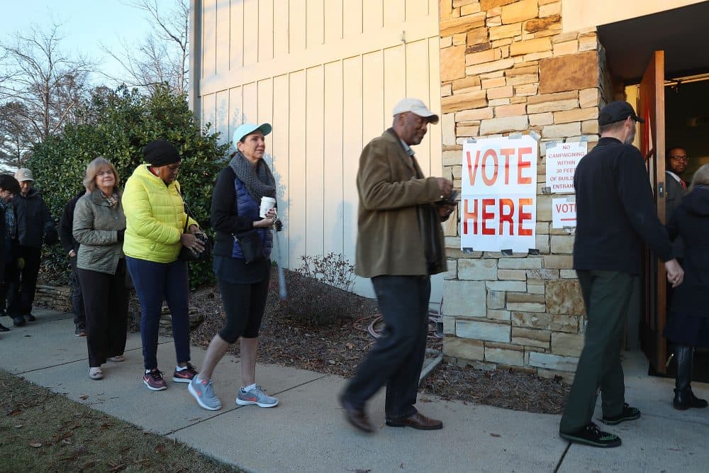 Voters head in to cast their ballot as the doors open at a polling station set up in the St. Thomas Episcopal Church on Dec. 12, 2017 in Birmingham, Ala. (Joe Raedle/Getty Images)