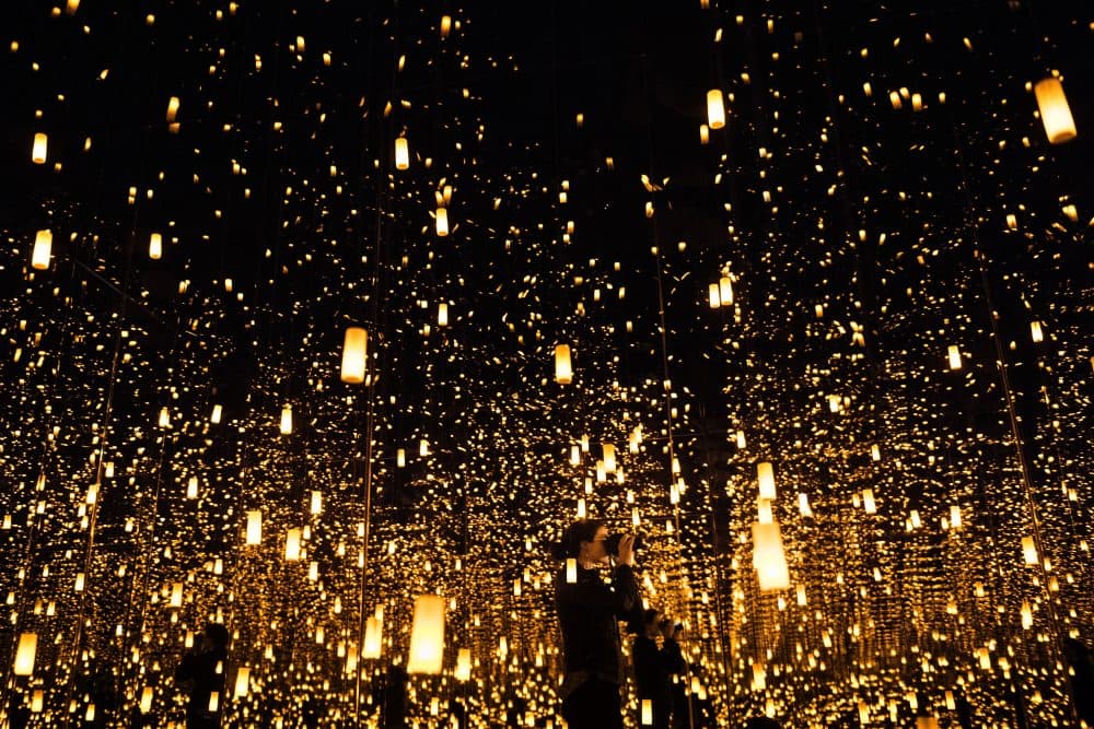 A woman photographs inside the &quot;Aftermath of Obliteration of Eternity&quot; room during a preview of the Yayoi Kusama's &quot;Infinity Mirrors&quot; exhibit at the Hirshhorn Museum on Feb. 21, 2017 in Washington, D.C. (Brendan Smialowski/AFP/Getty Images)