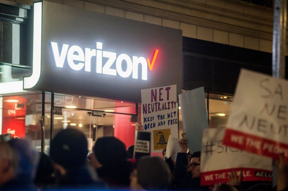Protestors gather on Bolyston Street in front of a Verizon store during a Net neutrality rally on December 7, 2017 in Boston, Mass. (Ryan McBride/AFP/Getty Images)