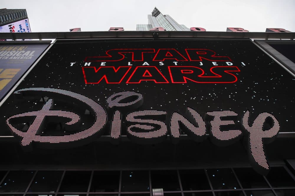The Disney logo is displayed outside the Disney Store in Times Square, Dec. 14, 2017 in New York City. The Walt Disney Company announced on Thursday that it had reached a deal to purchase most of the assets of 21st Century Fox. The deal has a total value of around $66 billion, with Disney assuming $13.7 billion of Fox's net debt. (Drew Angerer/Getty Images)