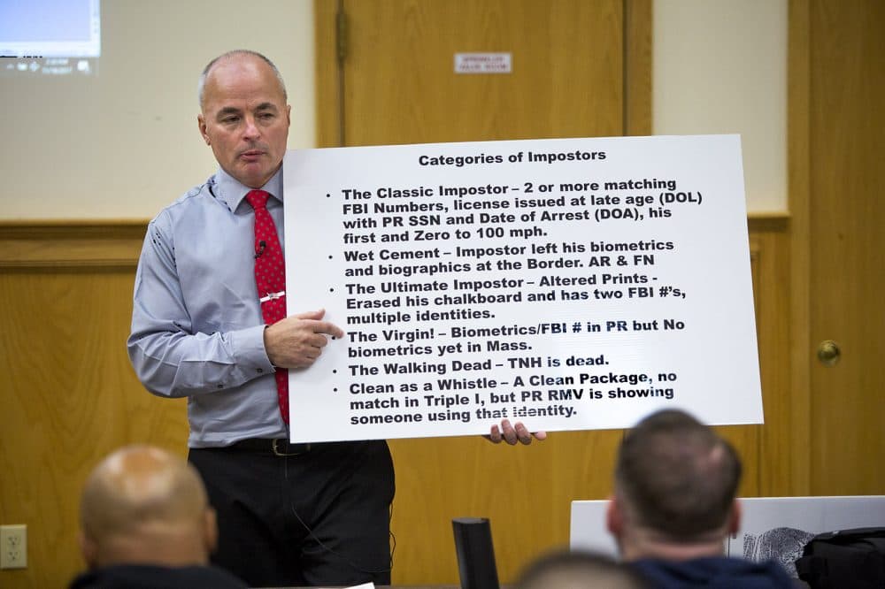 Officer James Scott of the Saugus Police Department holds up a placard with the categories of so-called &quot;impostors&quot; during an impostor training class at Bristol County Jail and House of Correction in North Dartmouth. (Jesse Costa/WBUR)