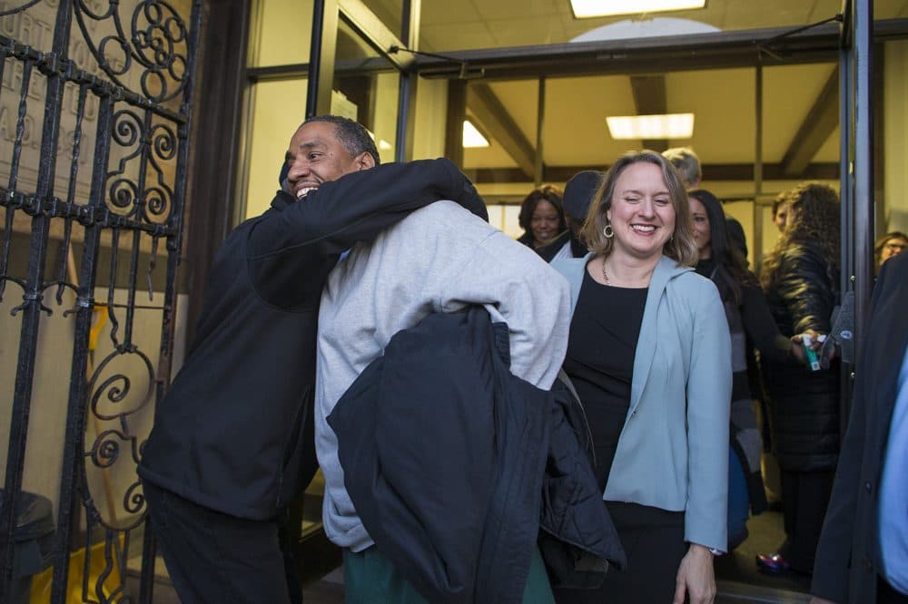 Darrell Jones walks out of the Plymouth County Superior Court in Brockton with his attorney Lisa Kavanaugh after he was released on bail Thursday after being incarcerated for 32 years for a crime he maintains he did not commit. (Jesse Costa/WBUR)