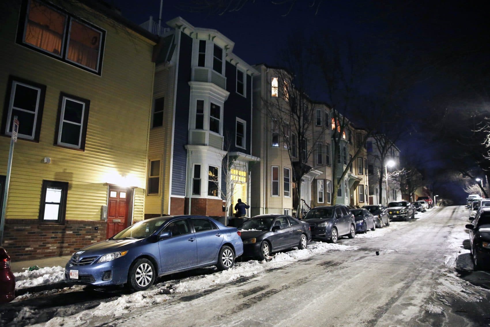 A person enters an apartment building on an icy street in the East Boston neighborhood of Boston as the temperature hovers in the single digits, Thursday, Dec. 28, 2017. The National Weather Service said there's the potential for record-breaking cold this week in New England. (AP Photo/Michael Dwyer)