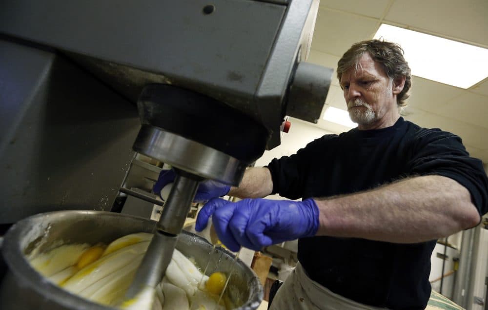 In this 2014 file photo, Masterpiece Cakeshop owner Jack Phillips cracks eggs into a cake batter mixer inside his store in Lakewood, Colo. (Brennan Linsley/AP)