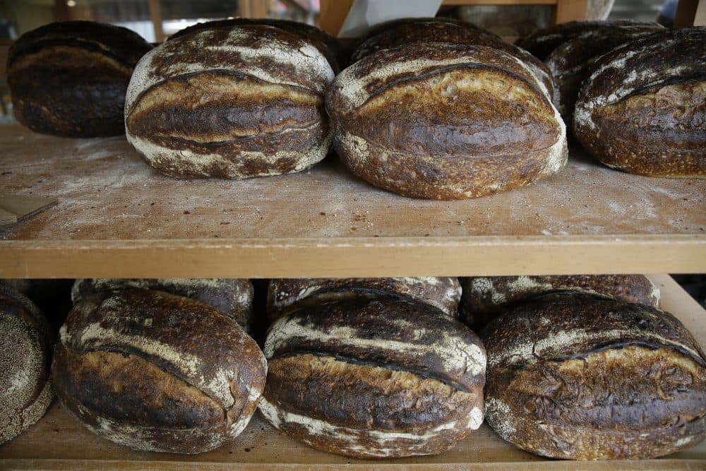 In this photo taken Friday, Aug. 11, 2017, are freshly baked loaves of bread on a rack at the Tartine Manufactory in San Francisco. For a bread lover, no destination is more alluring than San Francisco. (AP Photo/Eric Risberg)