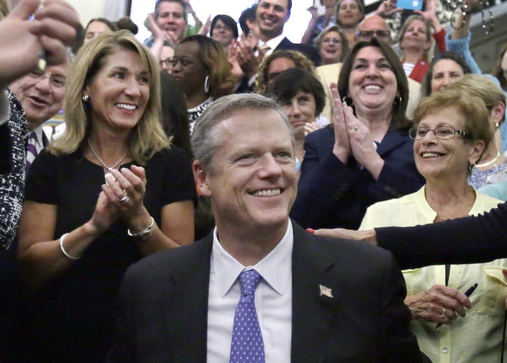 In this 2016 file photo, Gov. Charlie Baker smiles with Lt. Gov. Karen Polito, left, after he signed a bill into law at the State House in Boston. Baker and Polito both will seek a second term in the 2018 election. (Elise Amendola/AP)