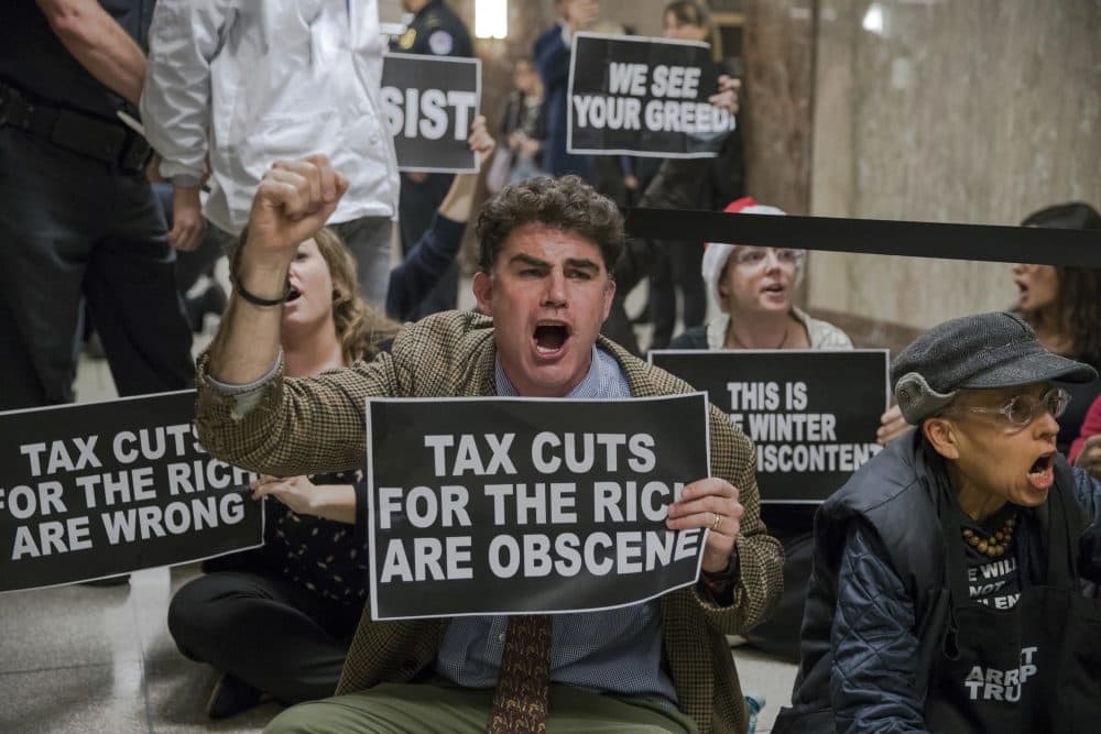 Protesters shout their disapproval of the Republican tax bill outside the Senate Budget Committee hearing room on Capitol Hill in Washington, Tuesday, Nov. 28, 2017. (J. Scott Applewhite/AP)