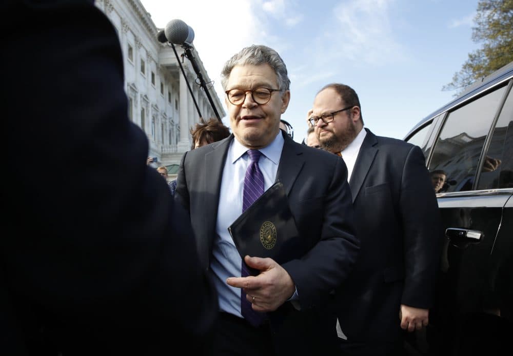 Sen. Al Franken, D-Minn., center, walks to his car as he leaves the Capitol after speaking on the Senate floor Thursday. Franken said he will resign from the Senate in coming weeks following a wave of sexual misconduct allegations. (Jacquelyn Martin/AP)