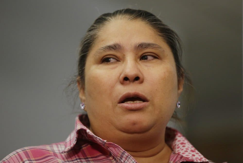 Gladys Fuentes, one of five female kitchen workers bringing a sexual harassment lawsuit against McCormick &amp; Schmick's, recounts her experiences Tuesday in Boston. (Stephan Savoia/AP)