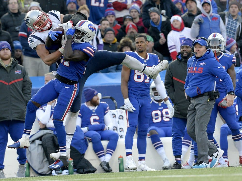 New England Patriots tight end Rob Gronkowski, left, makes a catch as Buffalo Bills cornerback Tre'Davious White (27) defends during the second half of an NFL football game, Sunday, Dec. 3, 2017, in Orchard Park, N.Y. Bills head coach Sean McDermott, right, looks on during the play. (AP Photo/Adrian Kraus)