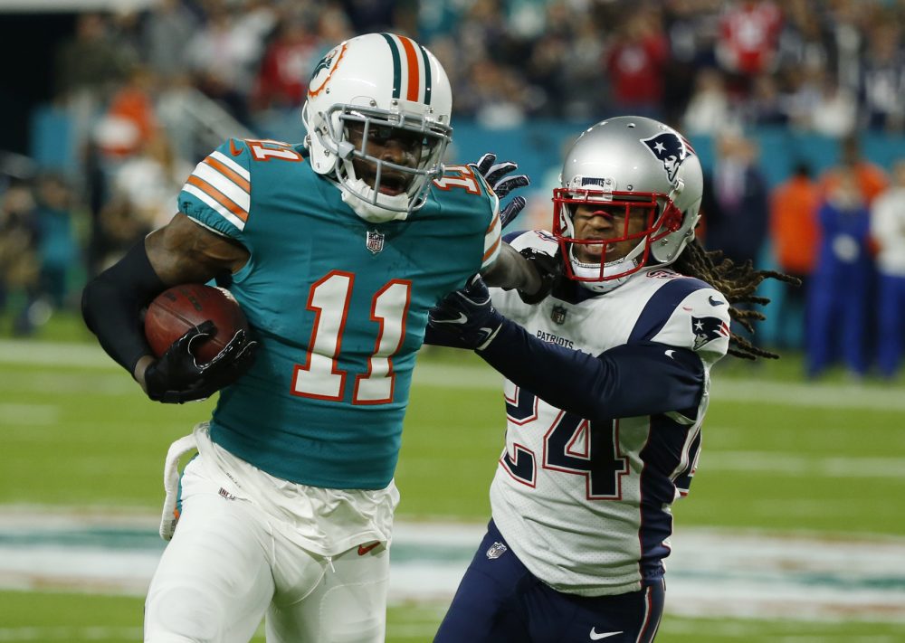 New England Patriots cornerback Stephon Gilmore (24) attempts to tackle Miami Dolphins wide receiver DeVante Parker (11), during the first half of an NFL football game, Monday, Dec. 11, 2017, in Miami Gardens, Fla. (AP Photo/Wilfredo Lee)