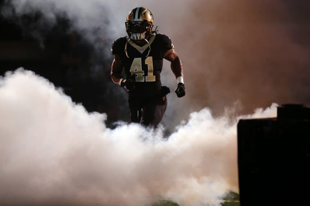 New Orleans Saints running back Alvin Kamara (41) runs on the field for player introductions during pre-game ceremonies before an NFL football game against the Carolina Panthers in New Orleans, Sunday, Dec. 3, 2017. (AP Photo/Gerald Herbert)