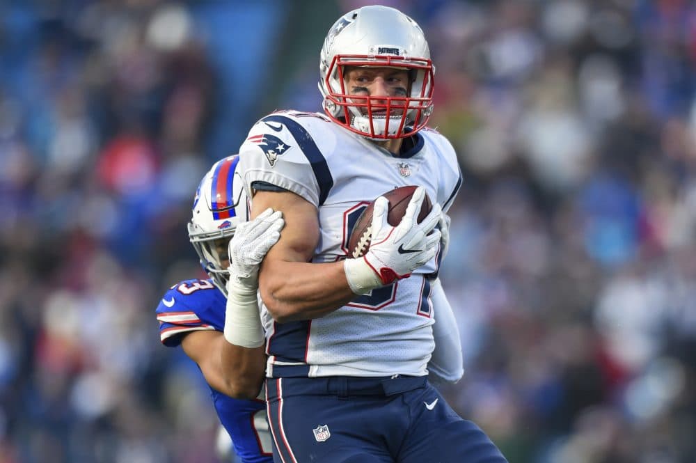 In this Dec. 3, 2017, file photo, New England Patriots tight end Rob Gronkowski (87) is tackled by Buffalo Bills strong safety Micah Hyde (23) during the second half of an NFL football game in Orchard Park, N.Y. Bills rookie cornerback Tre'Davious White says he's willing to forgive and forget Patriots tight end Rob Gronkowski for blindsiding him in the back of the head during Buffalo's loss to New England on Sunday, Dec. 3, 2017. (AP Photo/Rich Barnes, File)
