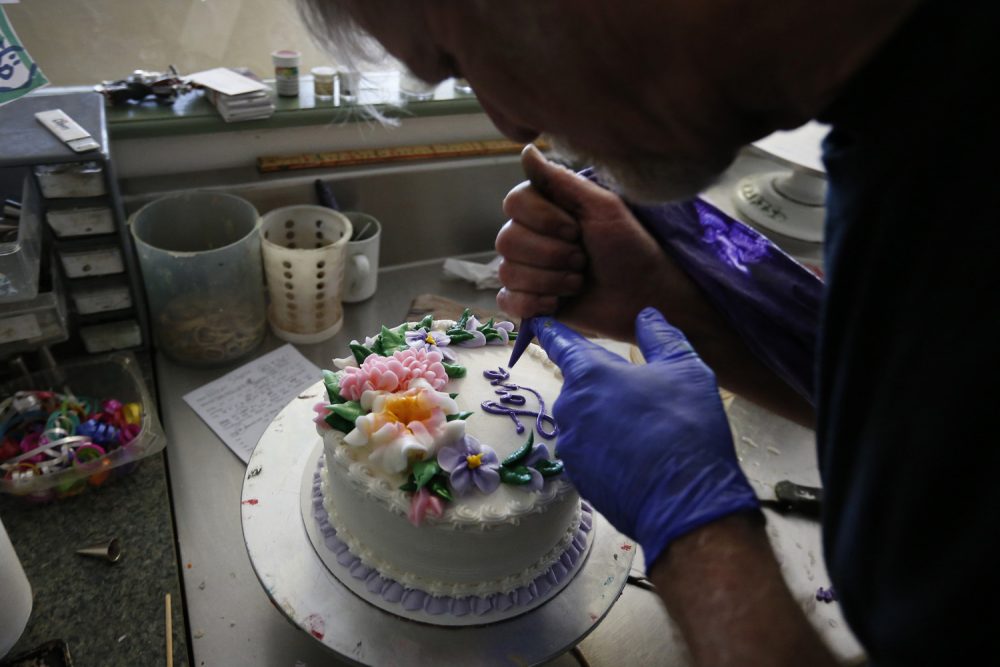 In this March 10, 2014 photo, Masterpiece Cakeshop owner Jack Phillips decorates a cake inside his store, in Lakewood, Colo. Phillips is appealing a recent ruling against him in a legal complaint filed with the Colorado Civil Rights Commission by a gay couple he refused to make a wedding cake for, based on his religious beliefs. (AP Photo/Brennan Linsley)