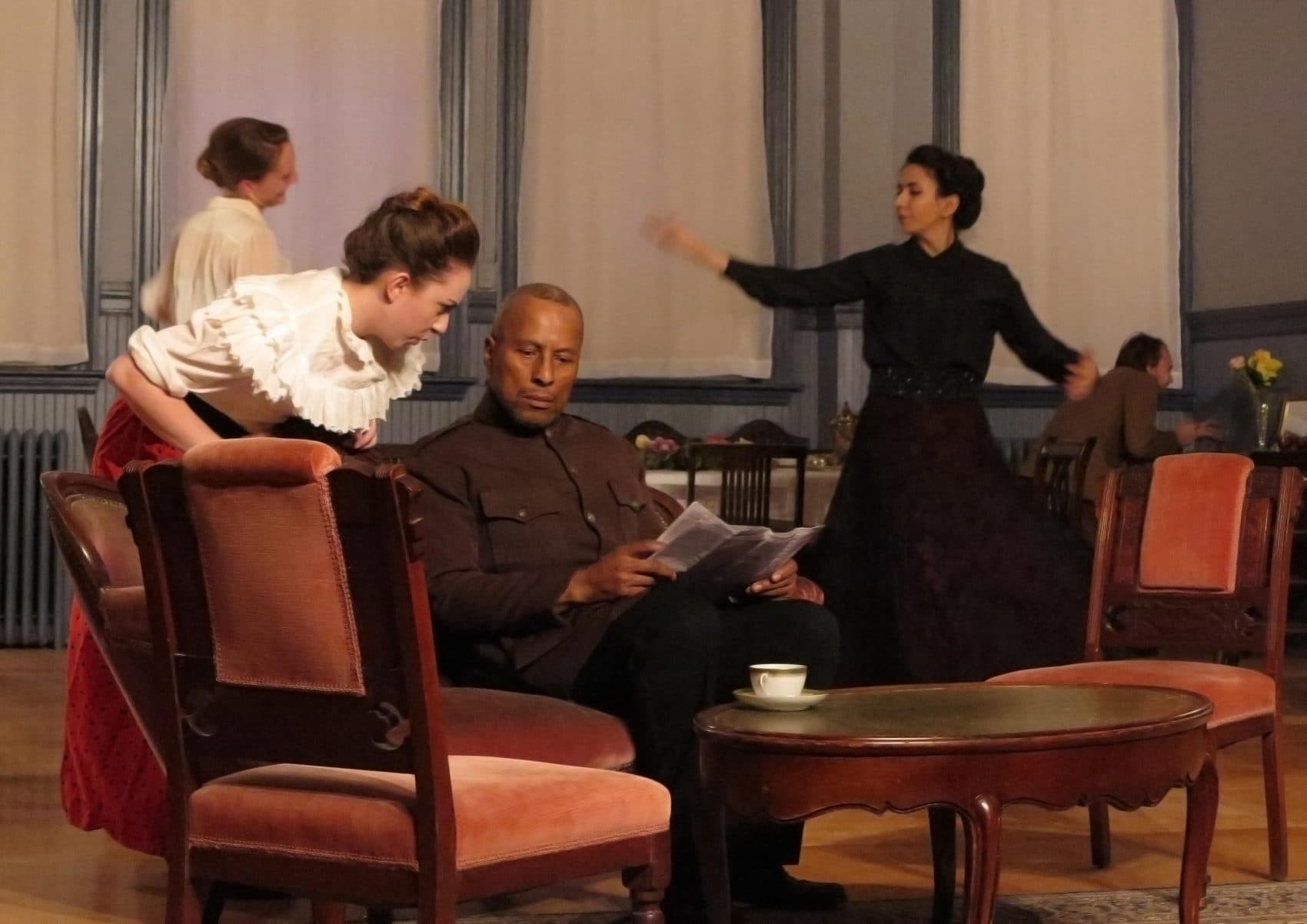 In the foreground, Olivia Dumaine as Natasha and Paul Benford-Bruce as Chebutykin. In the background, Siobhan Carroll as Irina, Deniz Khateri as Masha and Slava Tchoul as Fedotik US in &quot;Three Sisters.&quot; (Courtesy Danielle Fauteux Jacques)