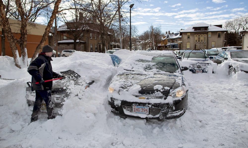 A Boston-area resident digs out their car after a big snowstorm in 2015. (Robin Lubbock/WBUR)