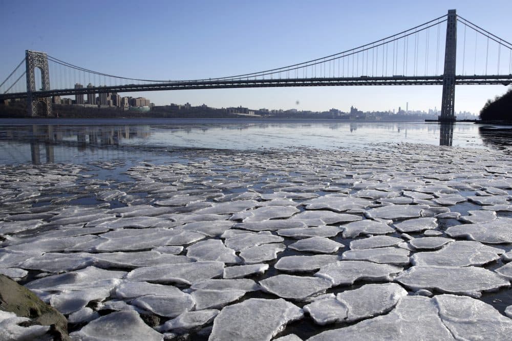 A layer of ice is broken into pieces floating along the banks of the Hudson River at the Palisades Interstate Park with the George Washington Bridge in the background, Tuesday, Jan. 2, 2018, in Fort Lee, N.J. (Julio Cortez/AP)