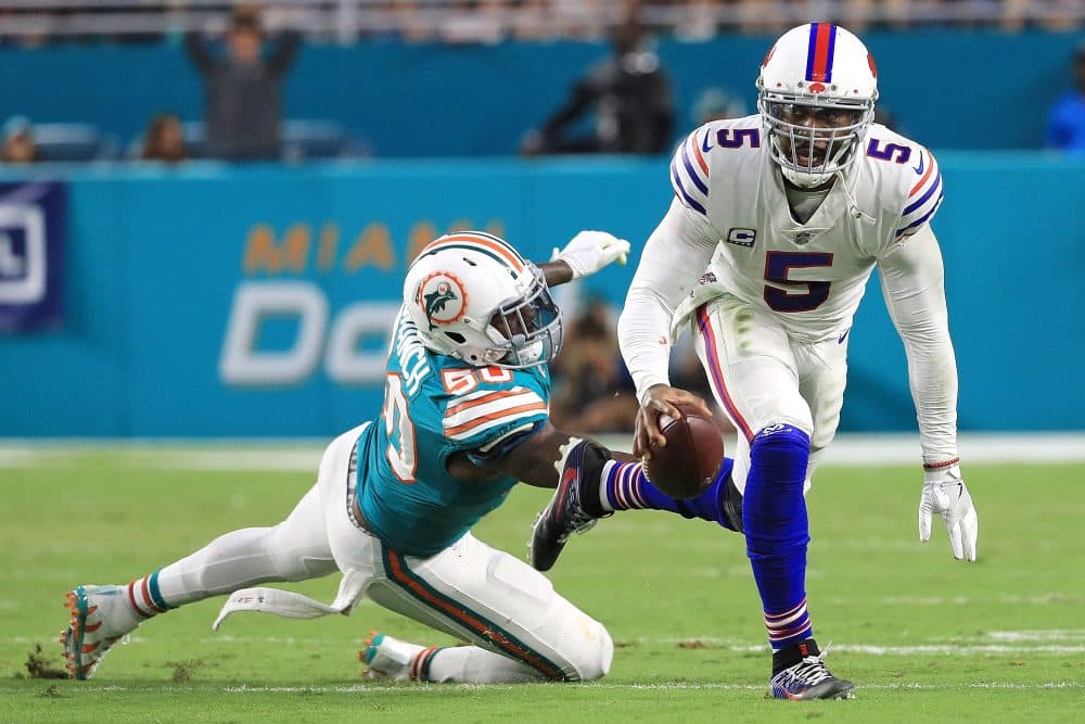 Tyrod Taylor of the Buffalo Bills avoids the tackle from Andre Branch of the Miami Dolphins during the second quarter at Hard Rock Stadium on Dec. 31, 2017 in Miami Gardens, Fla. (Mike Ehrmann/Getty Images)