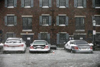 Cars sit in flood water from Boston Harbor on Long Wharf in Boston. (Michael Dwyer/AP)