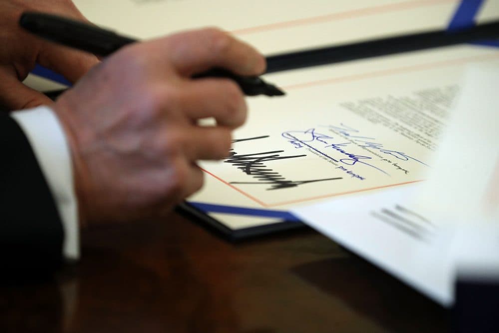 President Trump signs sweeping tax reform legislation into law in the Oval Office at the White House, Dec. 22, 2017 in Washington, D.C. (Chip Somodevilla/Getty Images)