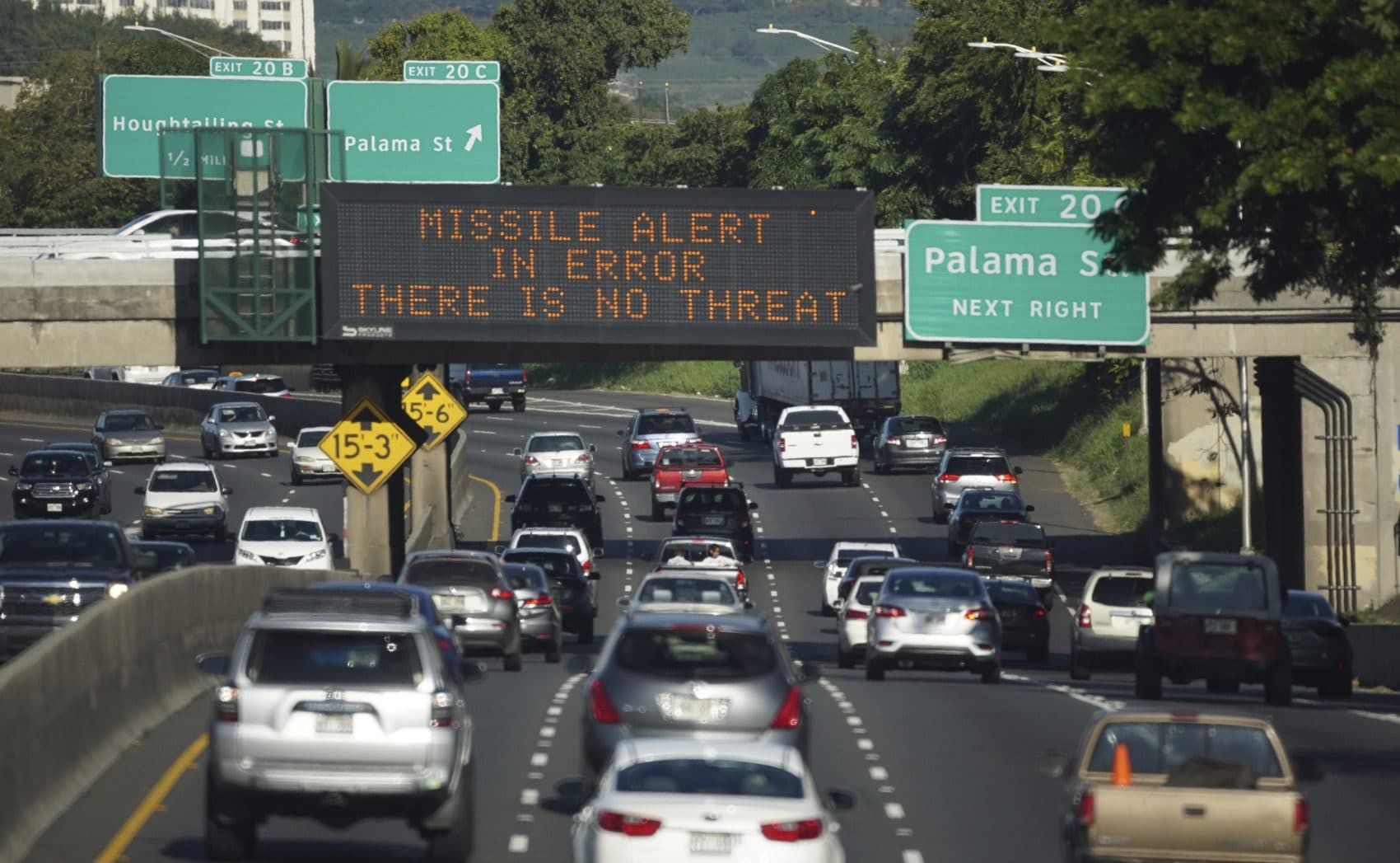 Cars drive past a highway sign Saturday in Honolulu, Hawaii alerting drivers that, contrary to an alert, there was no ballistic missile threat to the state. (Anthony Quintano/Civil Beat via AP)