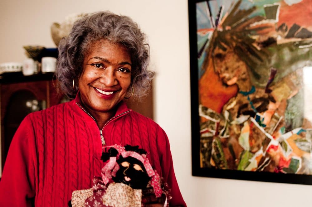 Dora Robinson in her living room in Springfield, Massachusetts. Her home is filled with artwork from the African diaspora that she's collected over the years. (Ben James/NEPR)