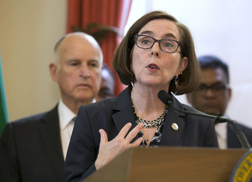 Oregon Gov. Kate Brown, center, discusses climate change at a news conference held by Calif., Gov. Jerry Brown, left, Tuesday, June 13, 2017,in Sacramento, Calif. During the event Fiji Prime Minister Frank Bainimarama, signed a subnational climate change agreement that calls for the signatories to reduce greenhouse gas emissions from 80 percent to 95 percent, below 1990 levels. (Rich Pedroncelli/AP)